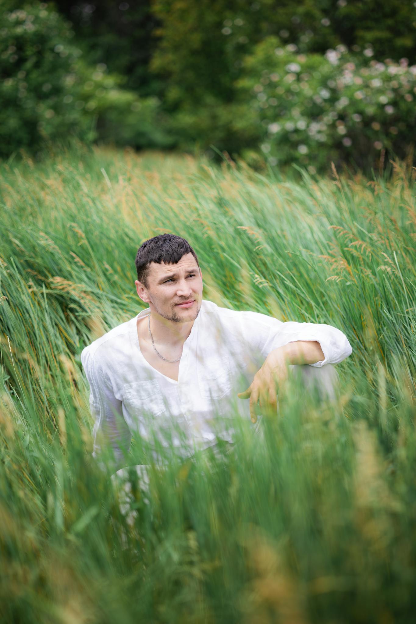 a handsome man resting on the grass